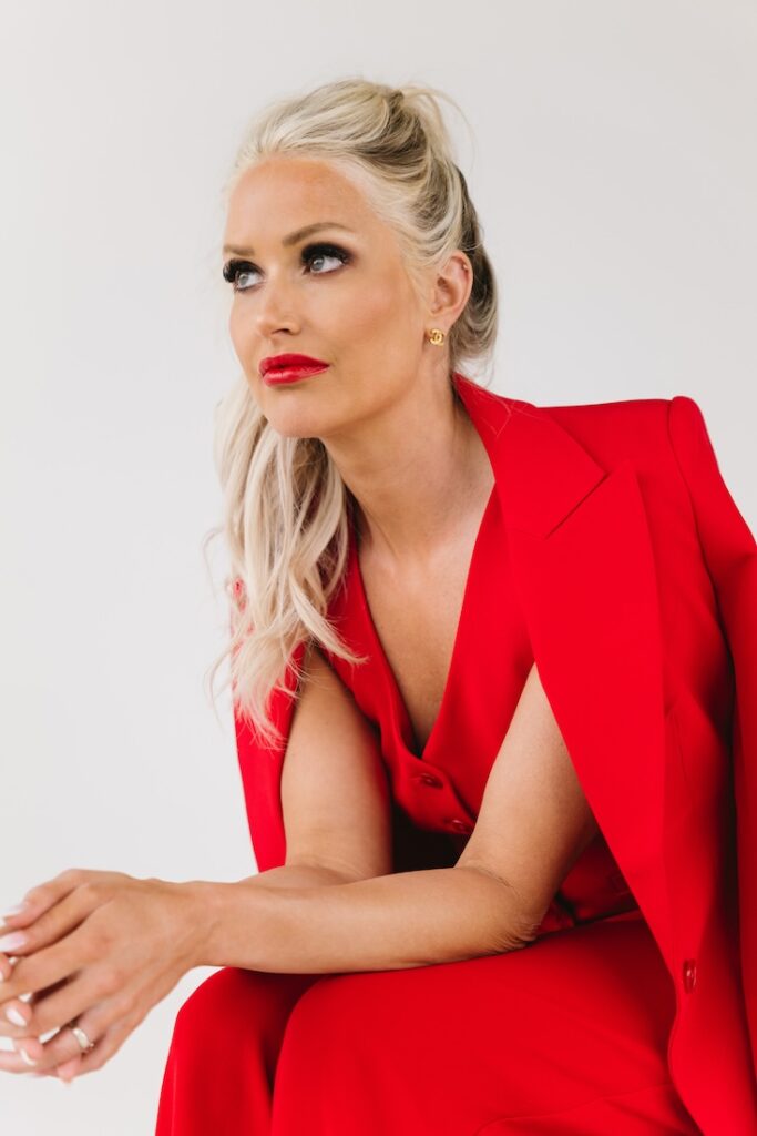 Modern brand photo of a female entrepreneur seated in red attire, taken during a Fargo branding session.