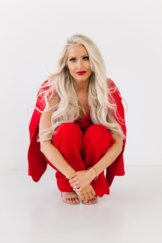 Personal branding photo of a woman entrepreneur in a red suit, showcasing confidence and style.
