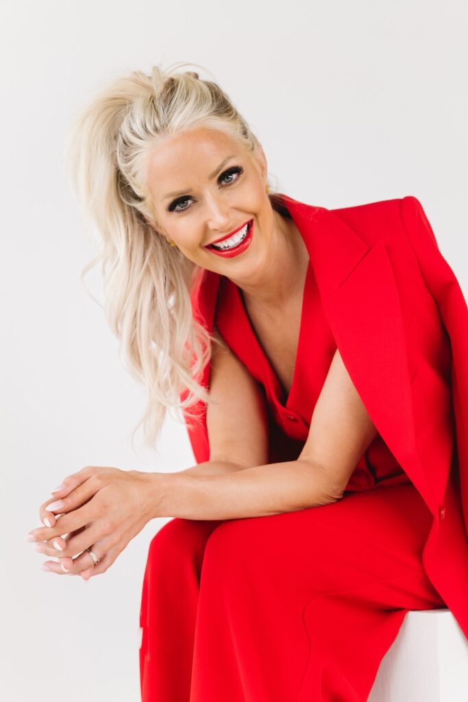 Candid brand photo of a mortgage lender laughing in bright red, captured during a small business branding photography session.